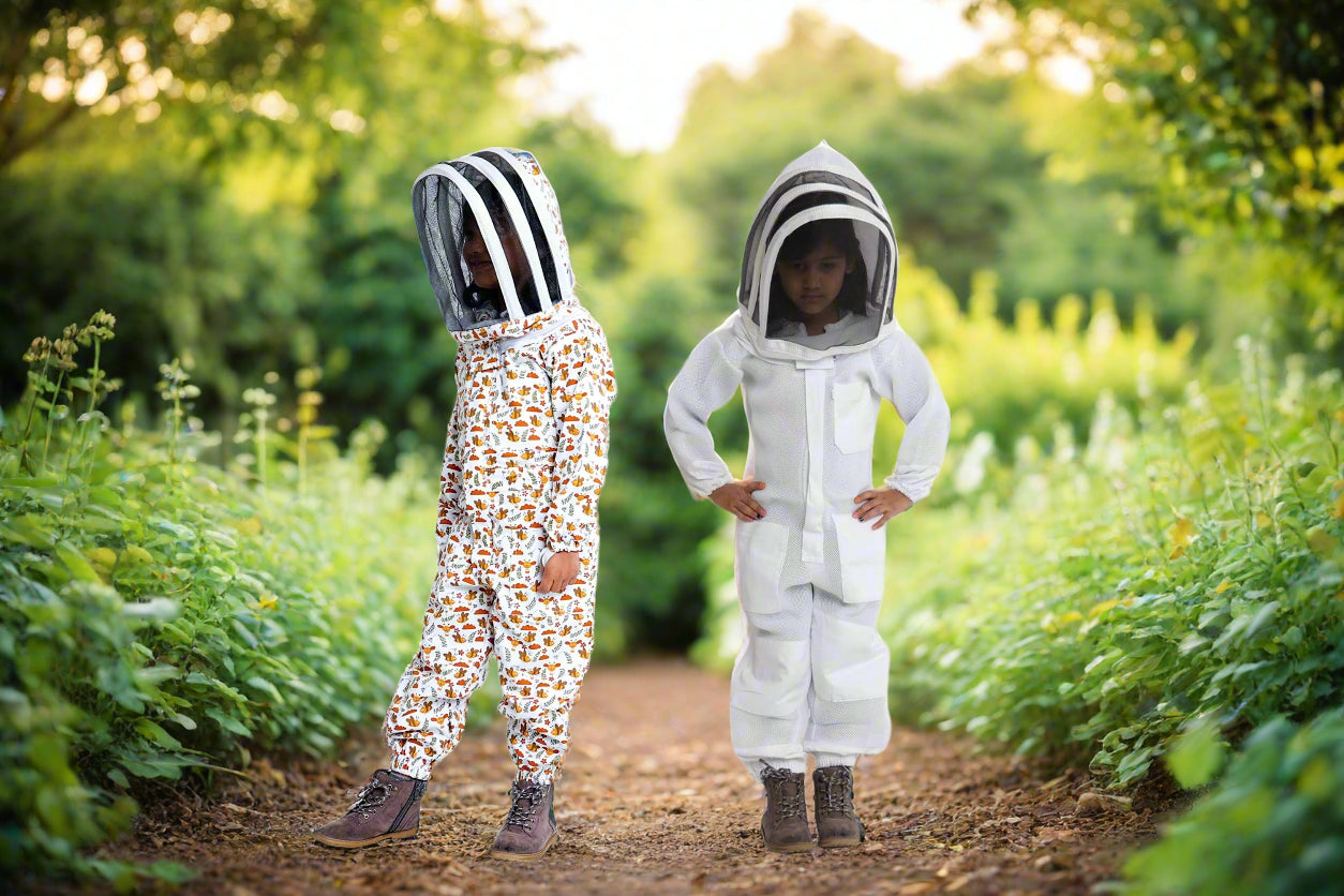 Children wearing ventilated beekeeping suits with protective veils safe and comfortable gear for young beekeepers